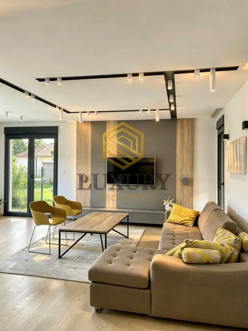 Modern and bright living room with a sofa and TV.
