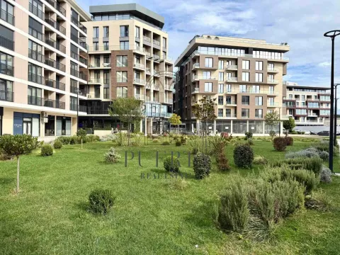 Modern residential buildings with a landscaped courtyard and lawn. - image 17