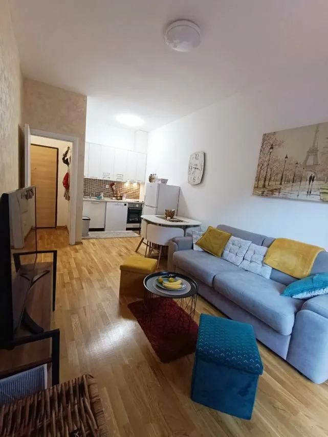 Living room with a sofa and dining area in an open-plan space.