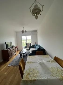 Bright living room with a dining table and access to a balcony. - image 6