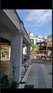 View of the exterior area and building entrance with columns. - image 3