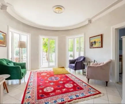 Spacious living room with seating furniture and large windows. - image 3