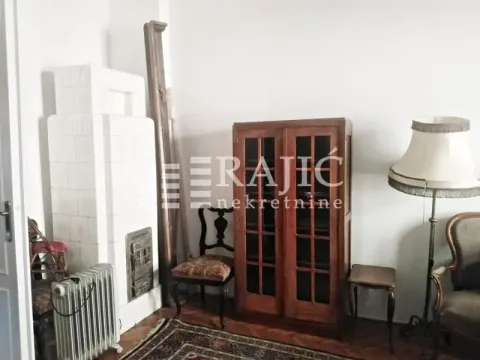 Living room with antique furniture, wood stove, and a lamp. - image 9