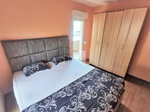 Furnished bedroom with a double bed and a large wardrobe. - image 8