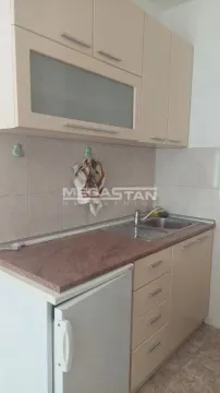 Small kitchen with a sink, countertop and wooden cabinets. - image 5