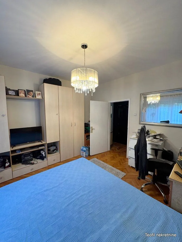 Furnished bedroom with a double bed, wardrobe, and a desk.