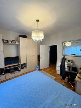 Furnished bedroom with a double bed, wardrobe, and a desk. - image 6