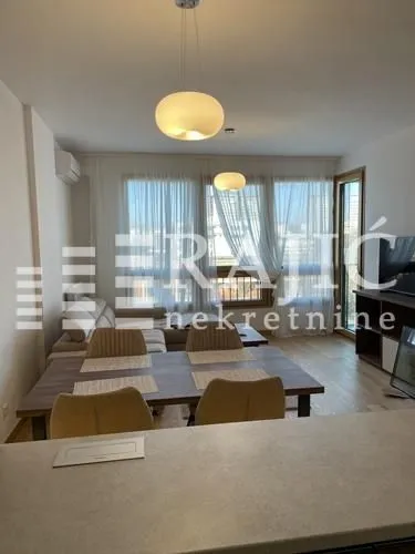 Living room with a dining area and sofa.