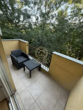Namešten balkon sa garniturom za sedenje i pogledom na zelenilo. - image 8