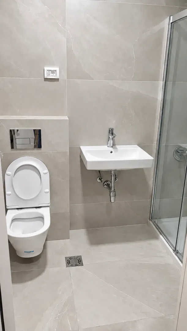 Modern equipped bathroom with a shower cabin.