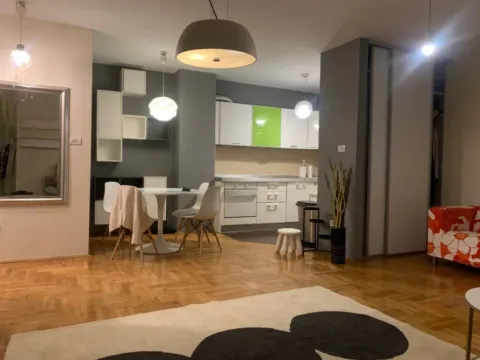 Living room with dining area and kitchen in the background. - image 7