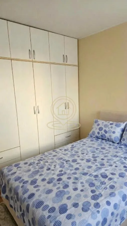 Bedroom with a double bed and a fitted wardrobe.