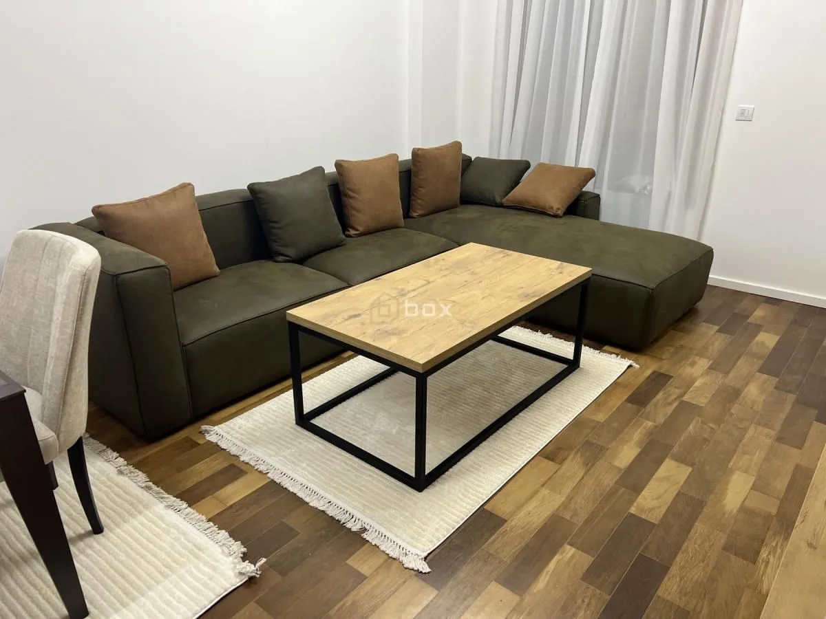 Living room with a corner sofa and coffee table.