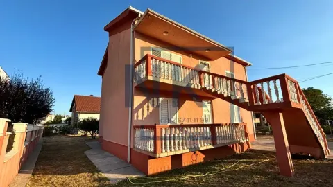 View of the exterior of a two-story house with an external staircase and terraces. - image 2