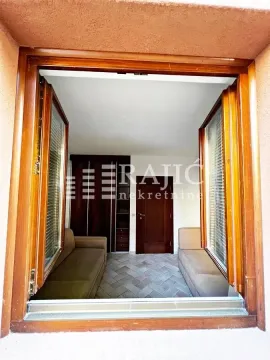 View through a wooden window into a furnished room with sofas and a wardrobe. - image 12