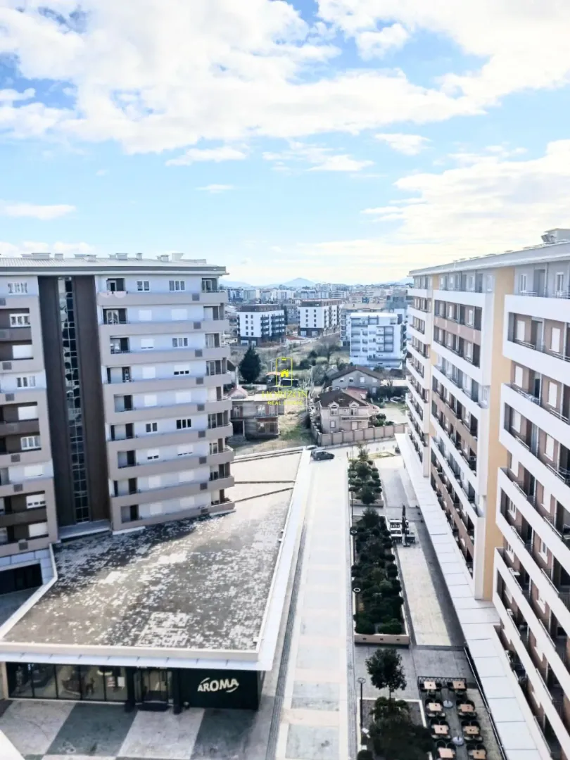 View from the terrace overlooking surrounding residential buildings and the city street.