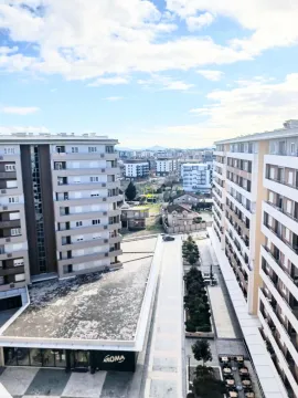 View from the terrace overlooking surrounding residential buildings and the city street. - image 10