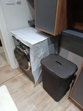 Laundry corner with washing machine and laundry basket. - image 12