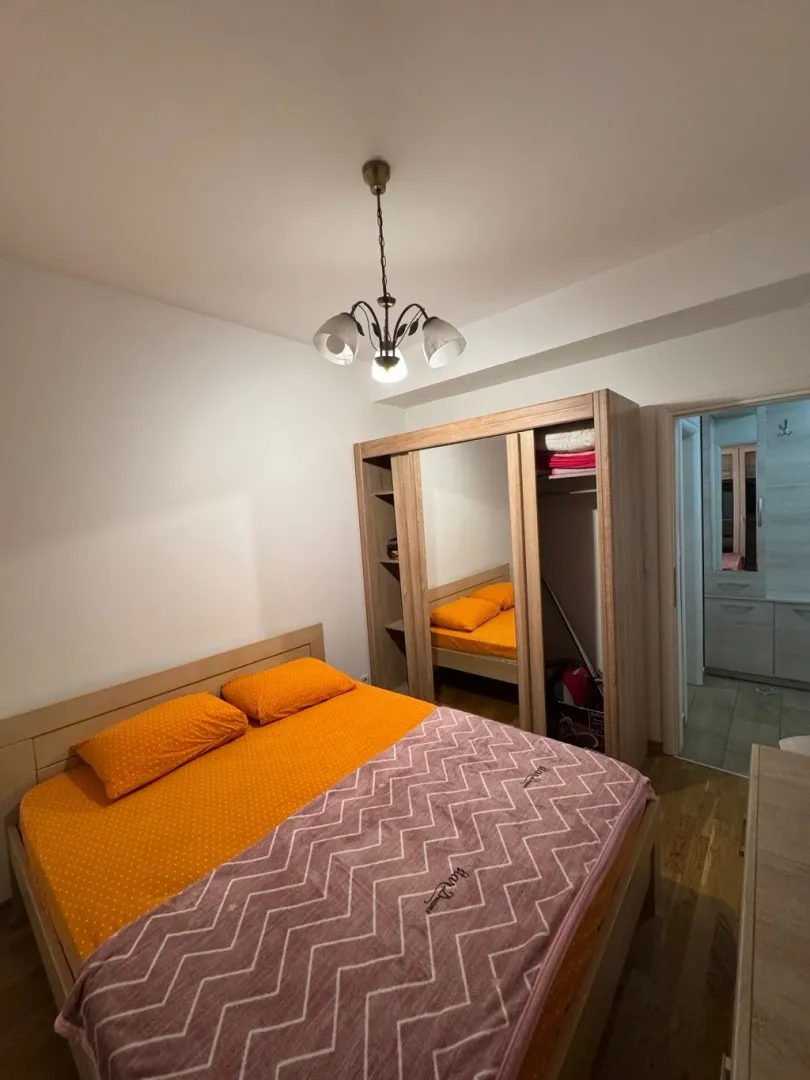 Bedroom with a double bed, wardrobe, and a view of the hallway.