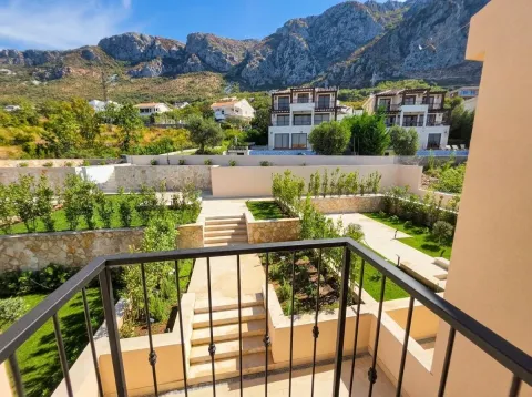 View from the balcony overlooking the landscaped yard and surrounding mountains. - image 17
