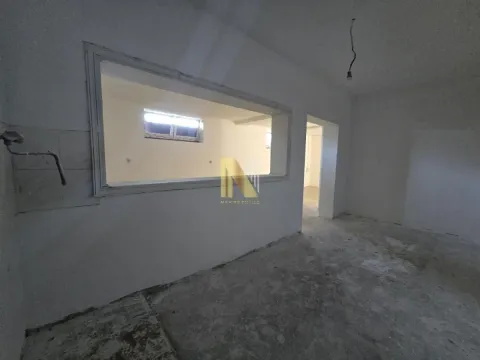 Empty room in rough construction phase with a wall opening. - image 15