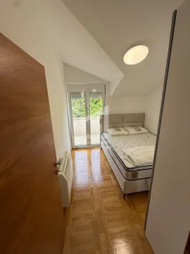 Smaller bedroom with a double bed and access to the terrace. - image 7