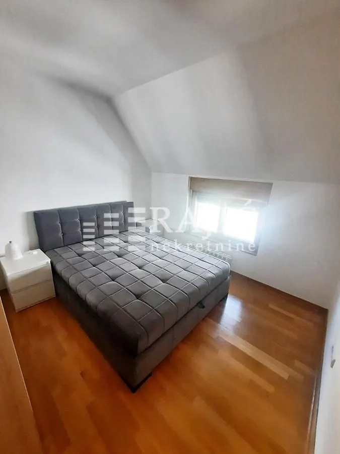 Bedroom with a double bed and wooden flooring.