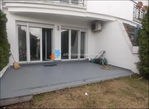 Tiled terrace in front of the building's ground floor entrance. - image 15
