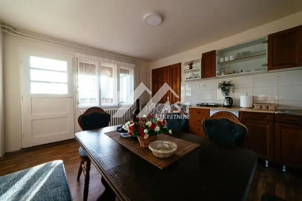 Kitchen with dining area and wooden furniture.