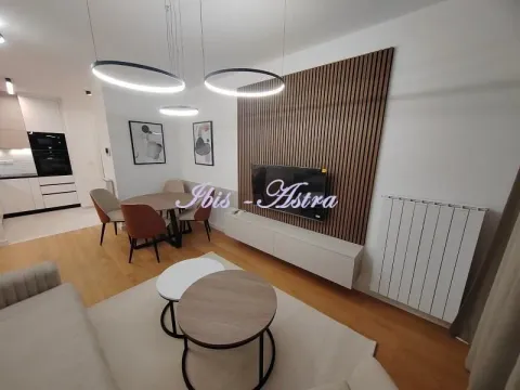 Living room with a dining area and a modern wooden wall panel. - image 2