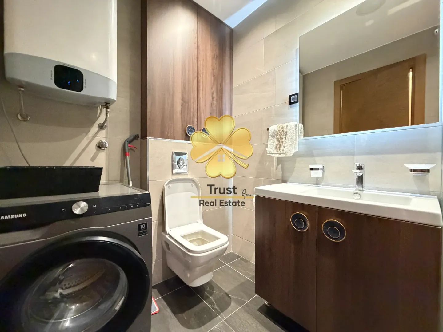 Modernly equipped bathroom with a washbasin and washing machine.
