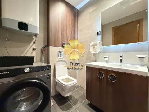 Modernly equipped bathroom with a washbasin and washing machine. - image 9