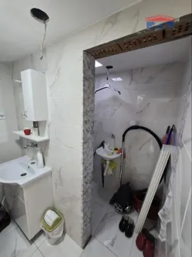 Small bathroom with a washbasin and ceramic tiles. - image 8