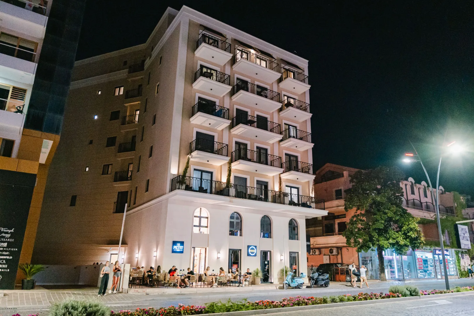 Night view of the building exterior featuring balconies and a ground floor venue.