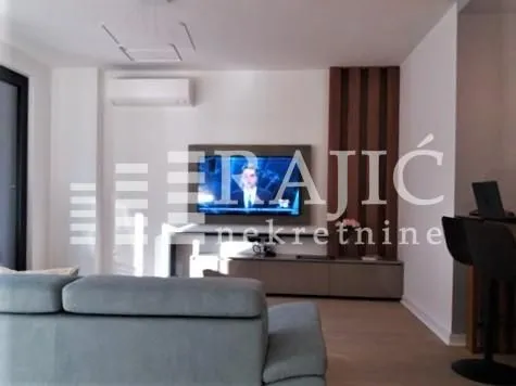 Living room with sofa and TV.