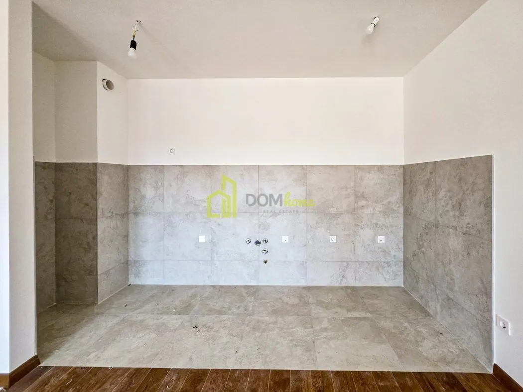 Unfurnished kitchen area with wall tiles and utility connections.