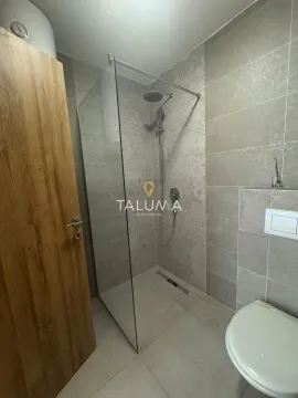 Modern bathroom with a walk-in shower and a built-in toilet. - image 4