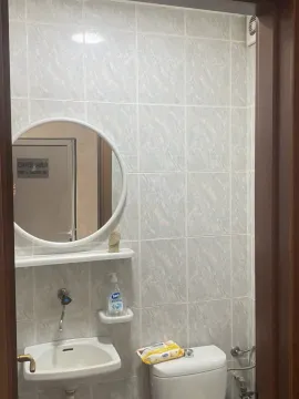 Small bathroom with a sink, mirror, and toilet. - image 5