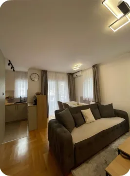Living room with a sofa and a dining area in the back. - image 17