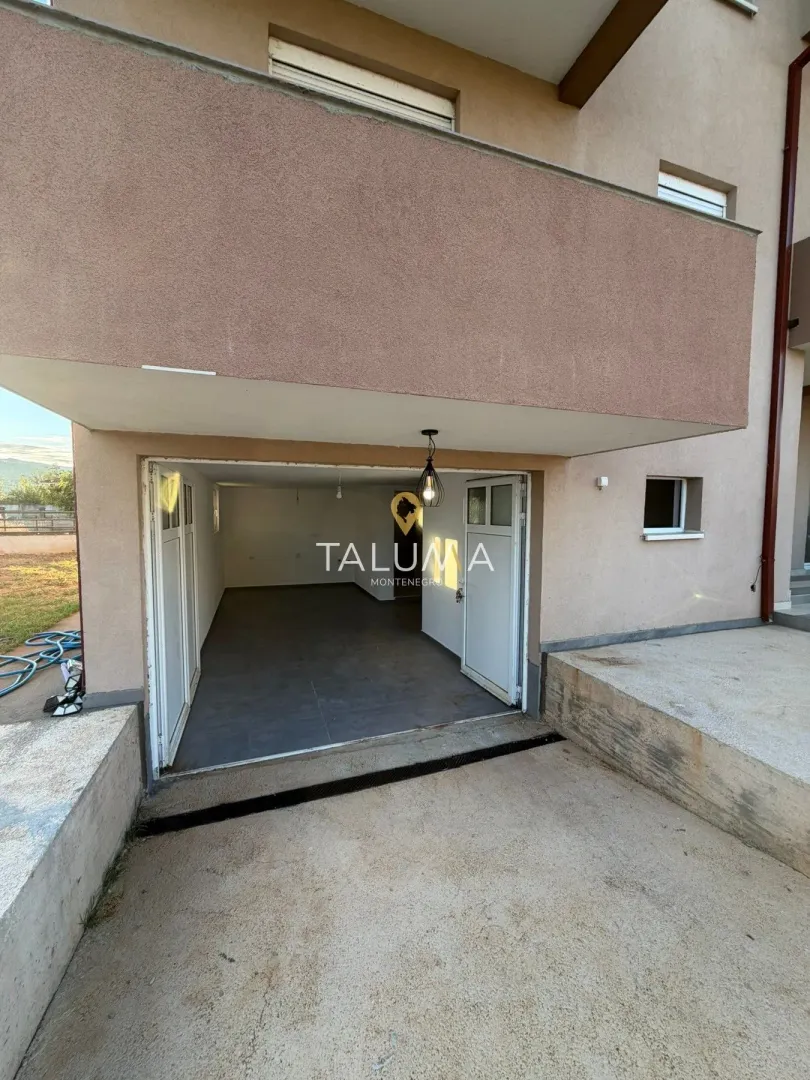 View of the garage entrance and the building facade.