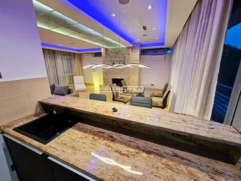 View from the kitchen with a breakfast bar towards the living room and dining area. - image 10