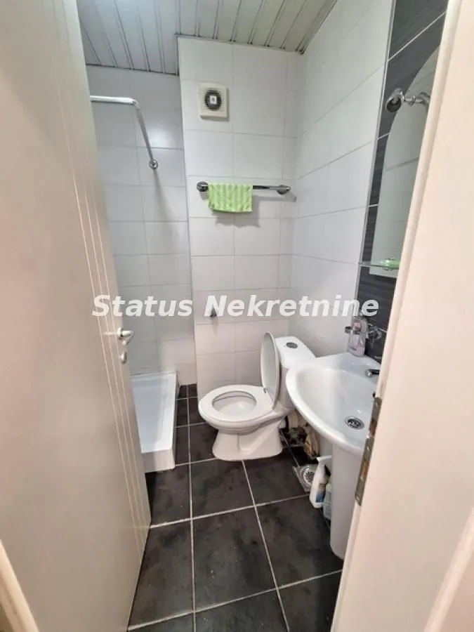 Manje kupatilo sa tuš kabinom, umivaonikom i wc šoljom.