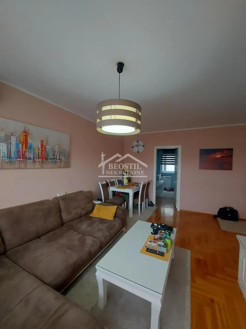 Living room with a sofa set and a dining area.
