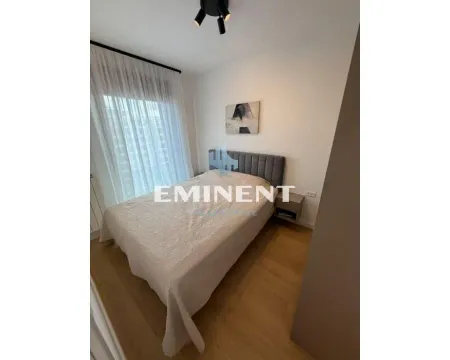 Furnished bedroom with a double bed, bedside table, and window with curtains. - image 6
