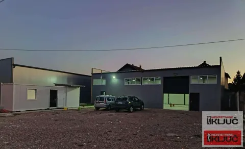 Exterior view of an industrial building with parking at dusk. - image 3