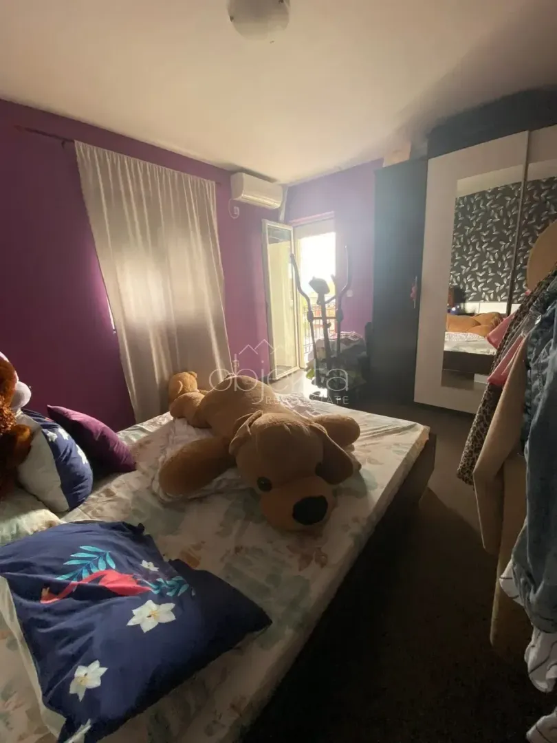 Bedroom with a bed, large stuffed toy, and wardrobe.