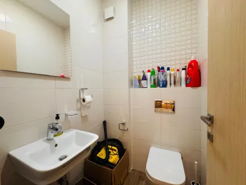 Small bathroom with a sink, toilet, and mirror. - image 14