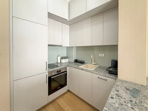 Modern kitchen with white cabinets and a built-in oven. - image 5