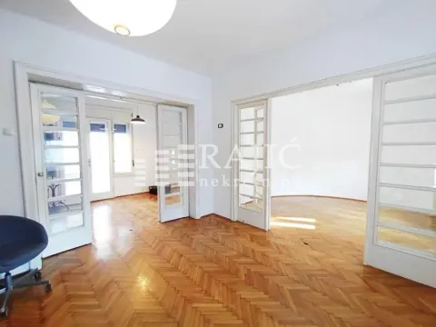 Spacious living room with hardwood parquet flooring and double glass doors. - image 4