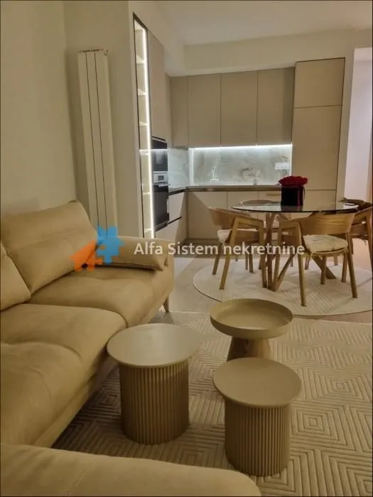 Living room with sofa and dining area in an open-plan space.